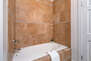 Master Bathroom with double sinks, soaking tub, and separate tiled shower