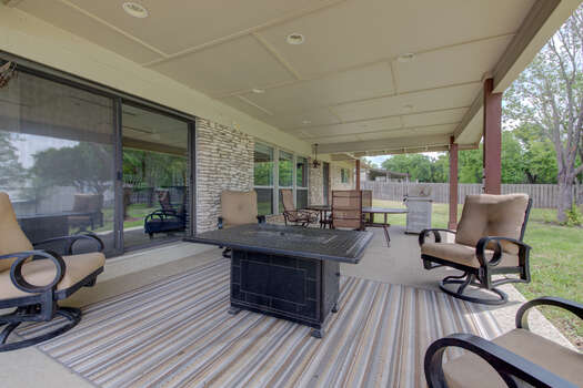 Main level back patio with a gas fire table and chairs