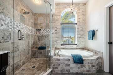 bathroom with walk in shower and soaking tub