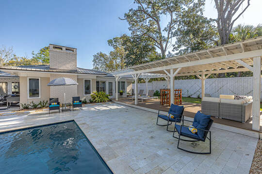 There's plenty of seating poolside for dining, sunning, or relaxing