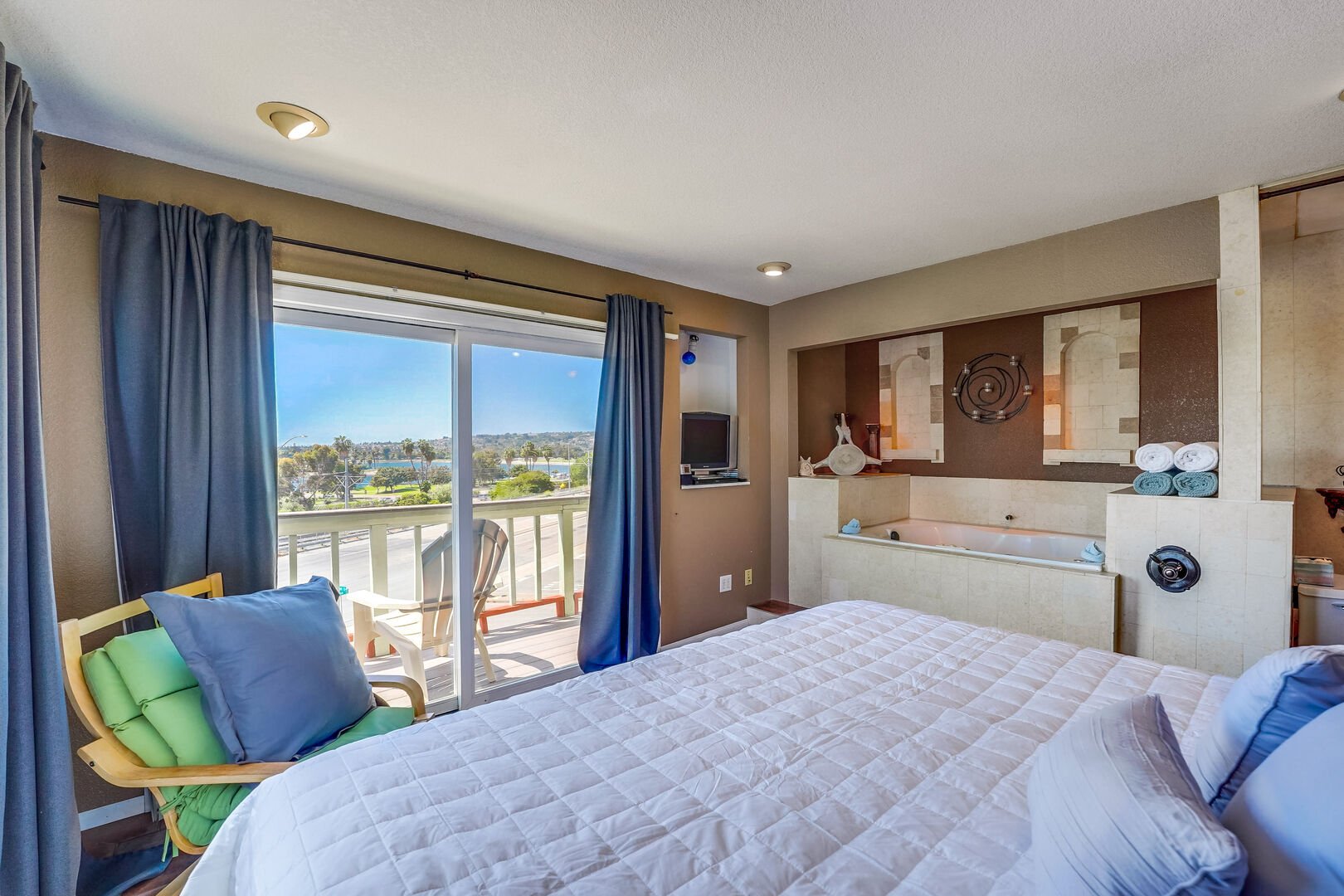 Private master bedroom with private balcony overlooking Mission Bay. Open jacuzzi tub and bathroom