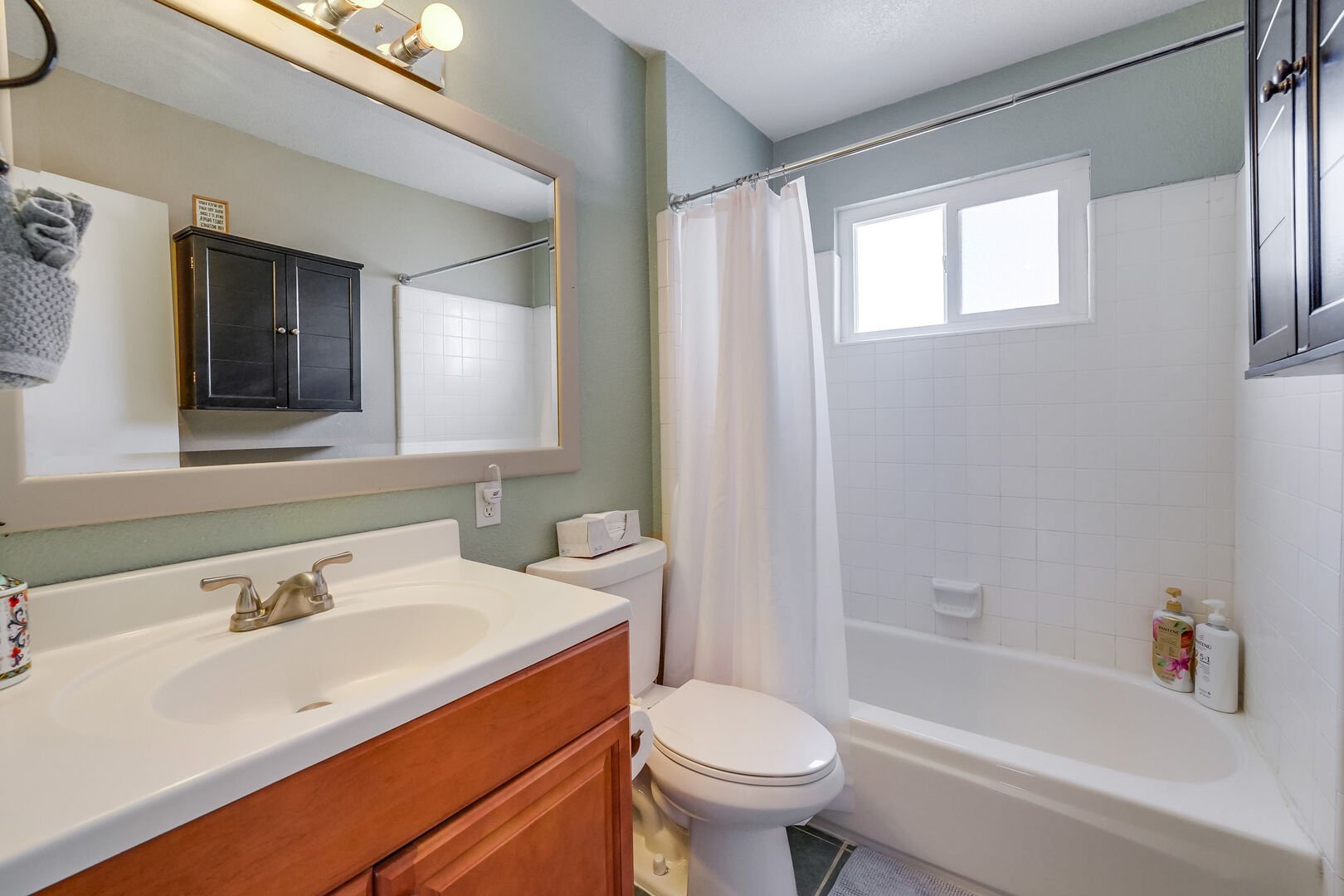Guest private full bathroom with shower/tub combo, shared between 2 guest rooms
