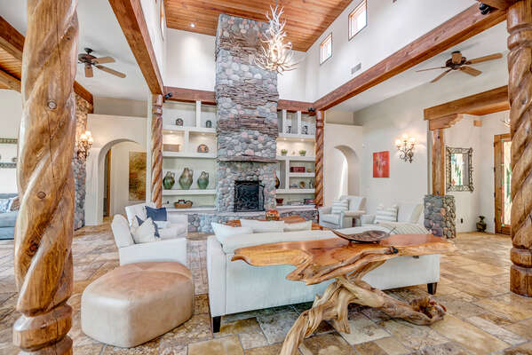 Gorgeous Living Room with Stone Fireplace, Antler Chandelier and Wood Posts!