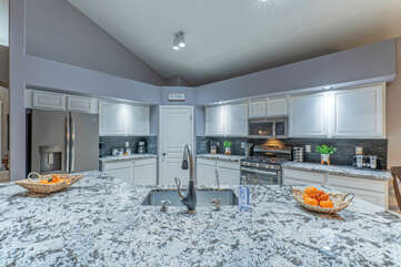 Modern kitchen is well stocked for preparing and serving home cooked meals.