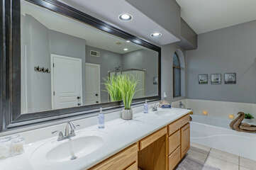 Dual vanity sinks in primary bath permit 2 to primp for special occasions.