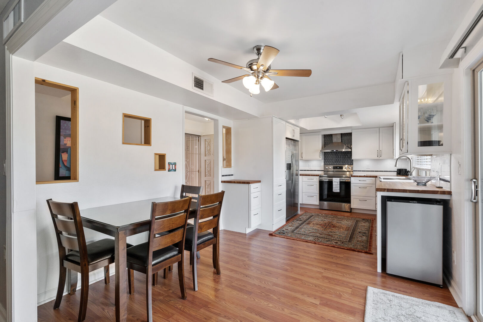 The long and spacious kitchen is a bright and beautiful place to create a meal together.