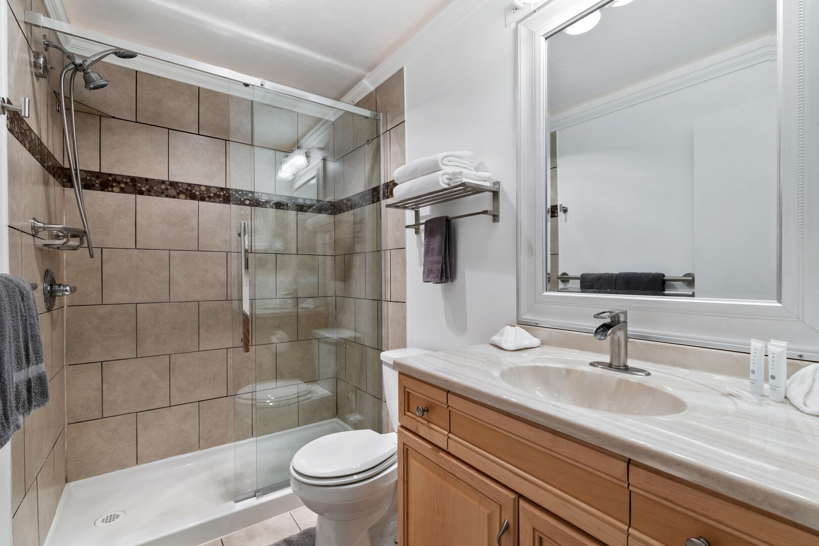 Bathroom two has a large walk-in shower and a spacious vanity.