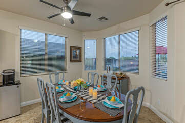 Dining area has table seating with views of the backyard oasis.