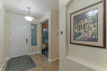 Charming front entrance foyer with doorway into den on left.
