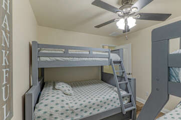 Upper twin bunk beds have safety rails and ladders.