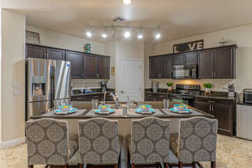Open kitchen has a central island with counter height seating.
