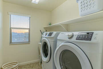 Fully stocked laundry room has family size washer and dryer to keep your wardrobe ready for the next adventure.