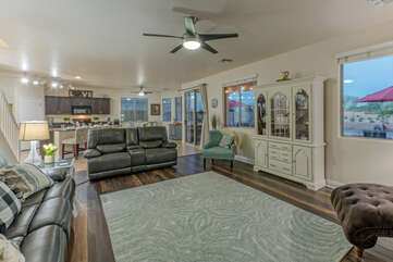 Great room's sitting area has large windows to oversee the backyard pool and patio.