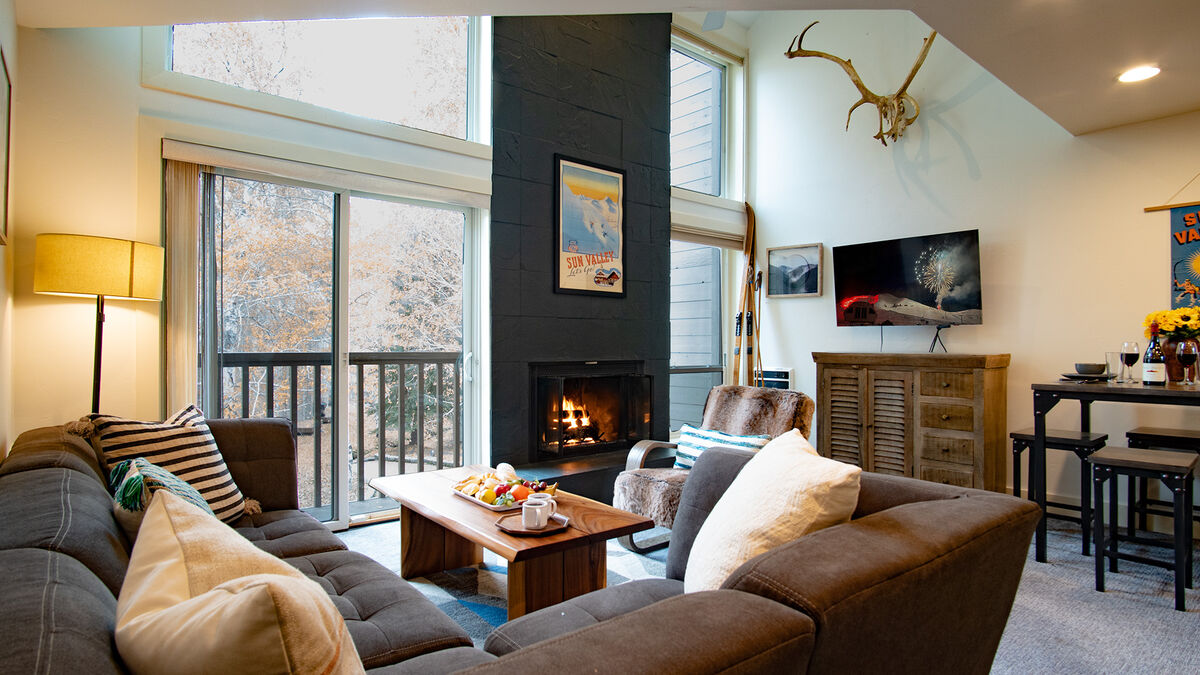 You're welcomed by a stylish, double-volume great room with a floor to ceiling fireplace for winter warmth