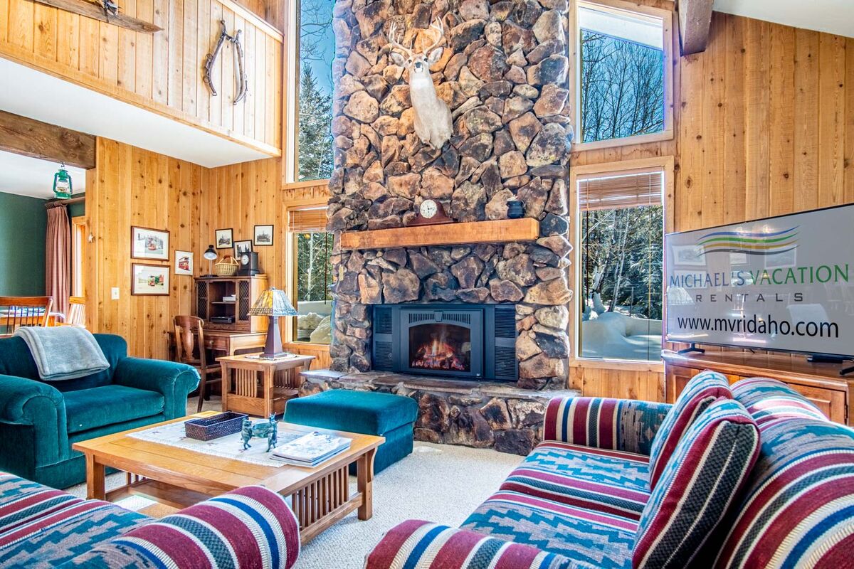 Relax by the fireplace in this sun-filled living room!