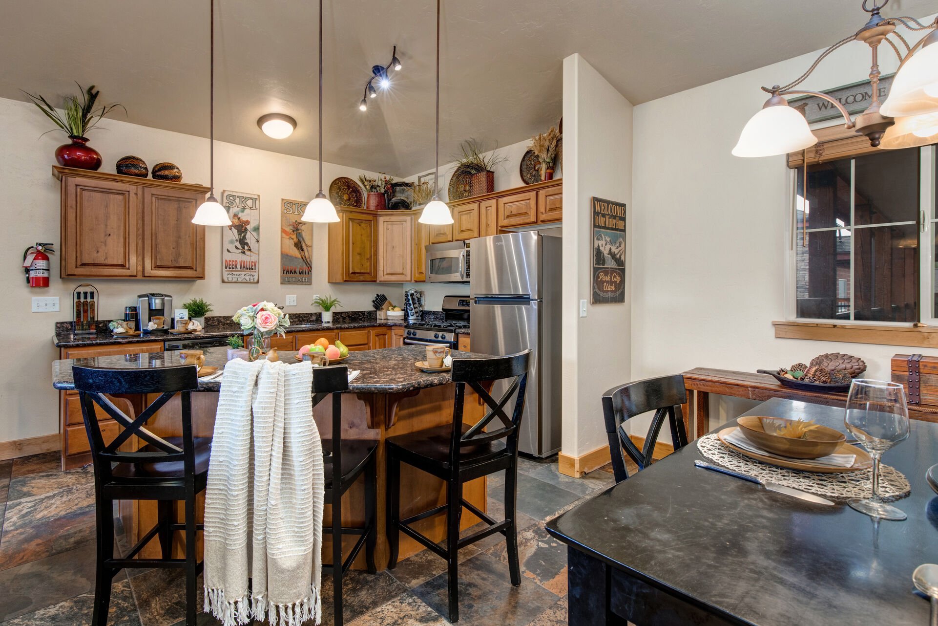 Fully Equipped Kitchen with stone countertops, stainless steel appliances, and island seating for three