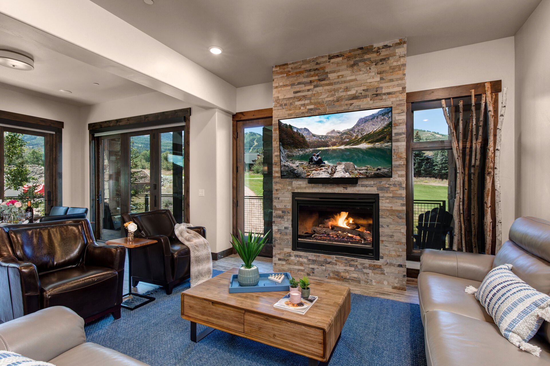 Living Room with smart TV, gas fireplace, and private deck access