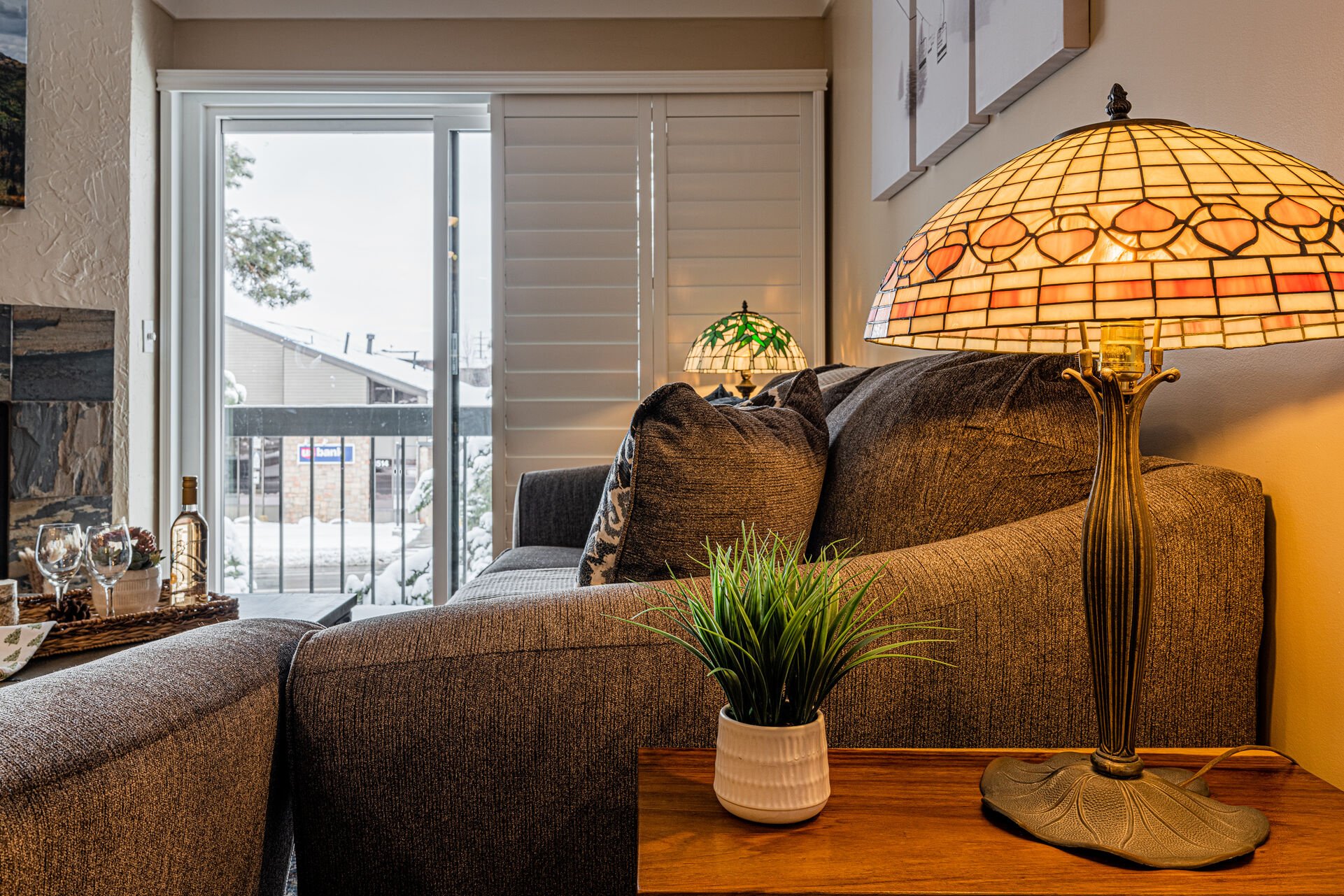 Modern furnishings including sofa sleeper, a cozy gas fireplace, and a 75” Smart TV