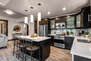 Fully Equipped Kitchen with beautiful stone countertops, stainless steel Viking appliances, and island seating for three