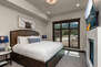 Master Bedroom with king bed, en suite bath, TV, and fireplace