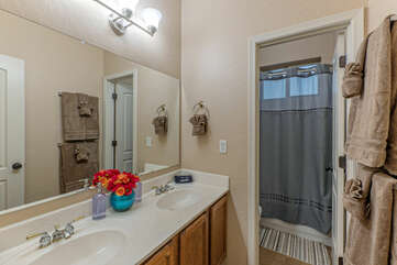 Bathroom 2 is upstairs and features dual sinks plus an enclosed tub-shower combo and commode.