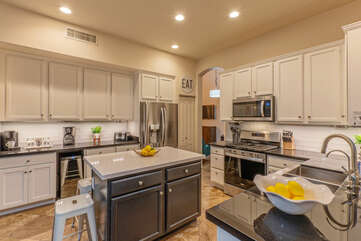 Fully stocked kitchen includes modern appliances and both Keurig and drip coffee makers.