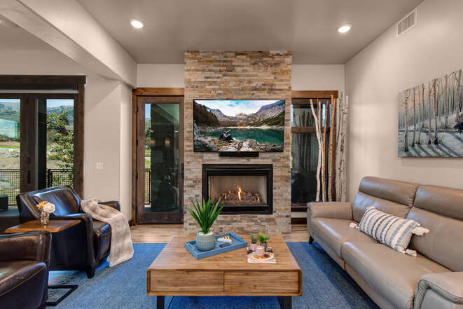 Living Room with smart TV, gas fireplace, and private deck access