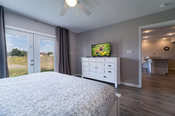 Master bedroom showing French doors and TV