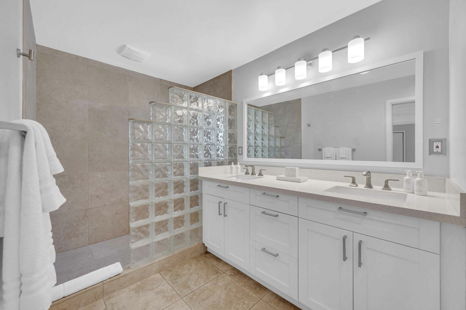 The primary bathroom features a walk-in shower and double sinks.