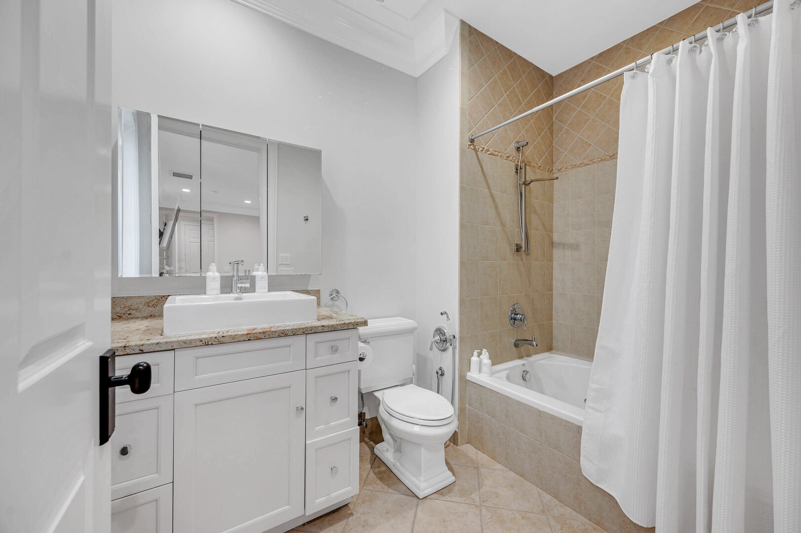 En-suite bathroom four features a tub and shower combo.