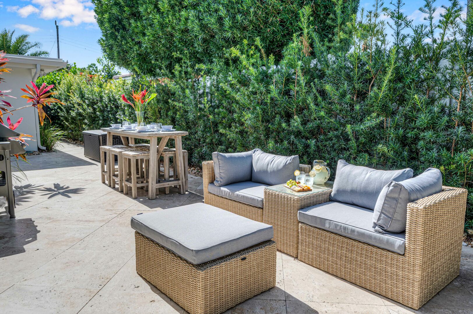 The outdoor oasis includes a sitting area, dining space, grill and quick access to the kitchen.