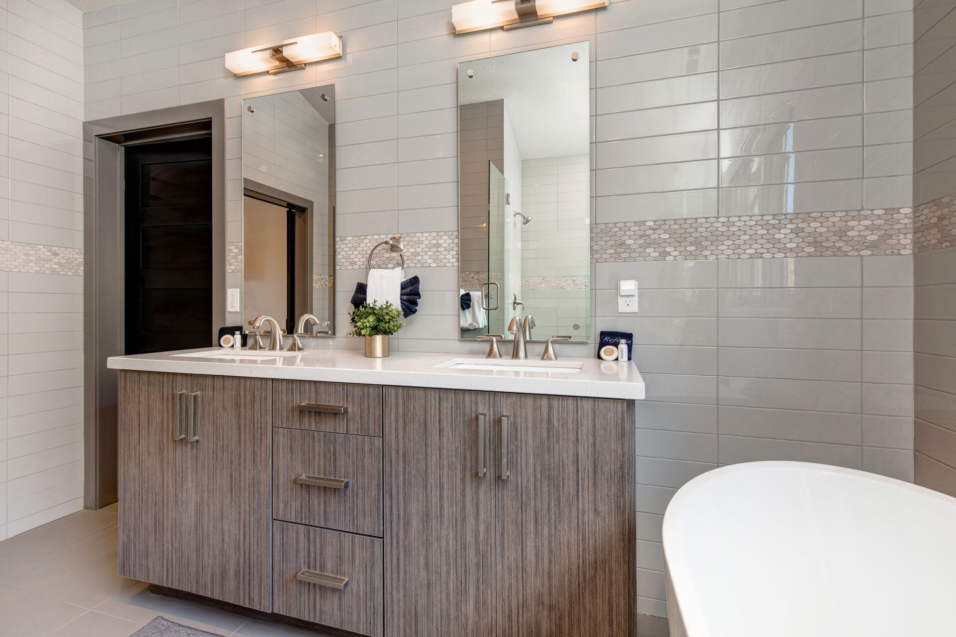 Master Bathroom with dual vanities, soaking tub, and oversized tile and glass shower