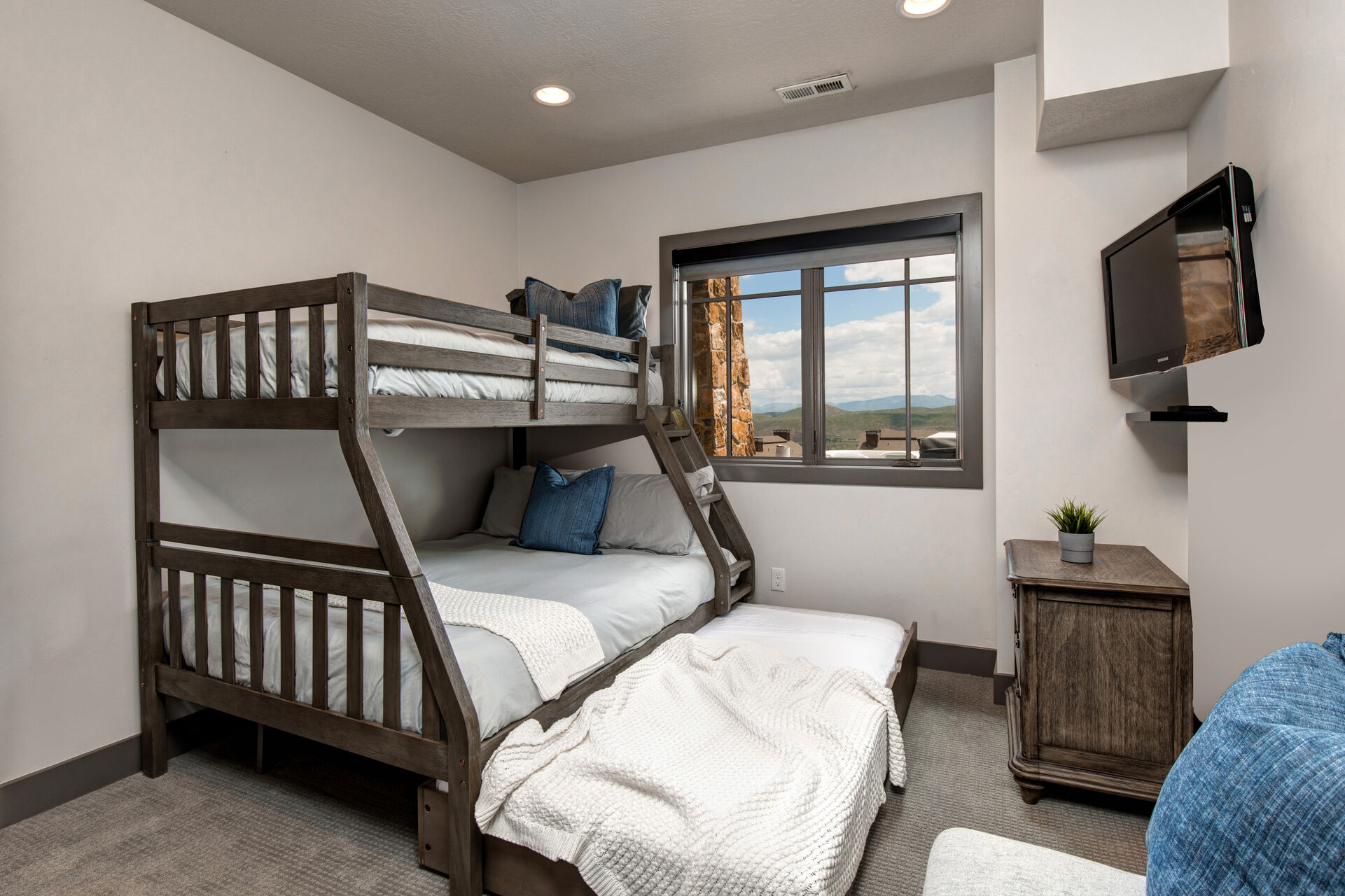 Lower Level Bunk Room with twin over full bunkbeds and twin trundle, smart tv, and full bath access