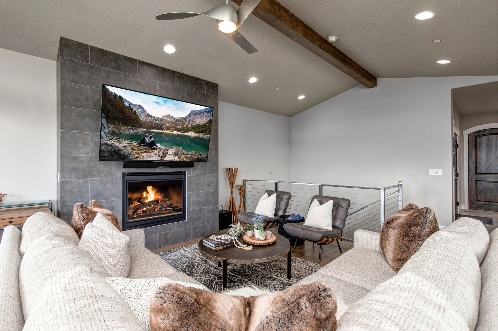 Living Room with plush oversized sectional sofa, smart tv, gas fireplace, and private deck access