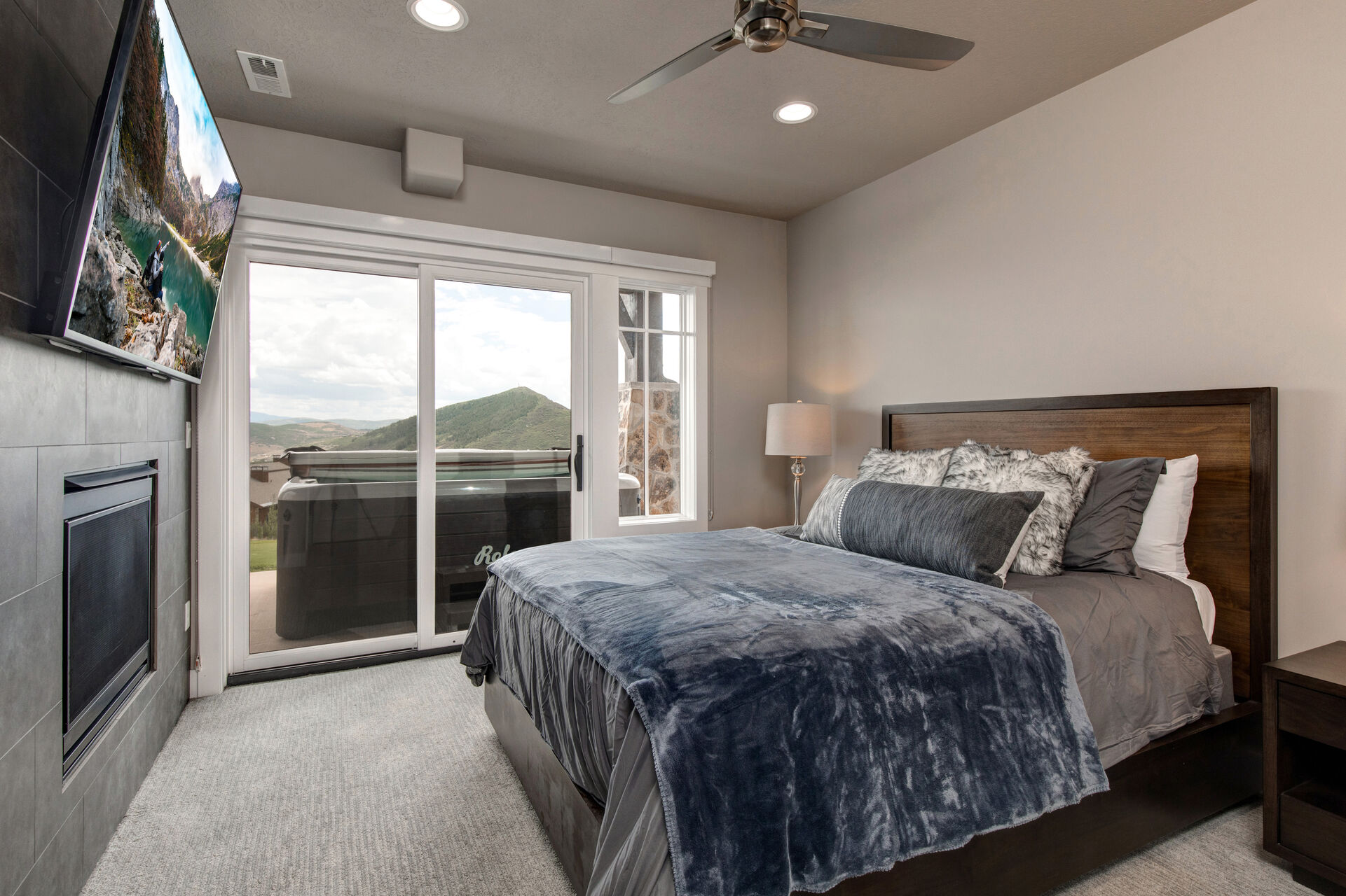 Lower Level Bedroom 2 with queen bed, gas fireplace, smart tv, hot tub patio access and full bath access