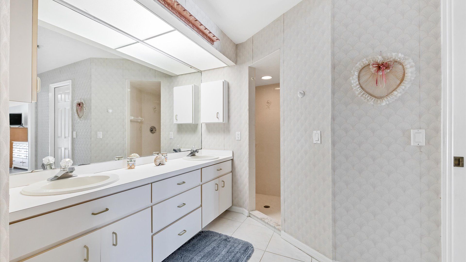 Ensuite master bathroom with shower and dual vanity