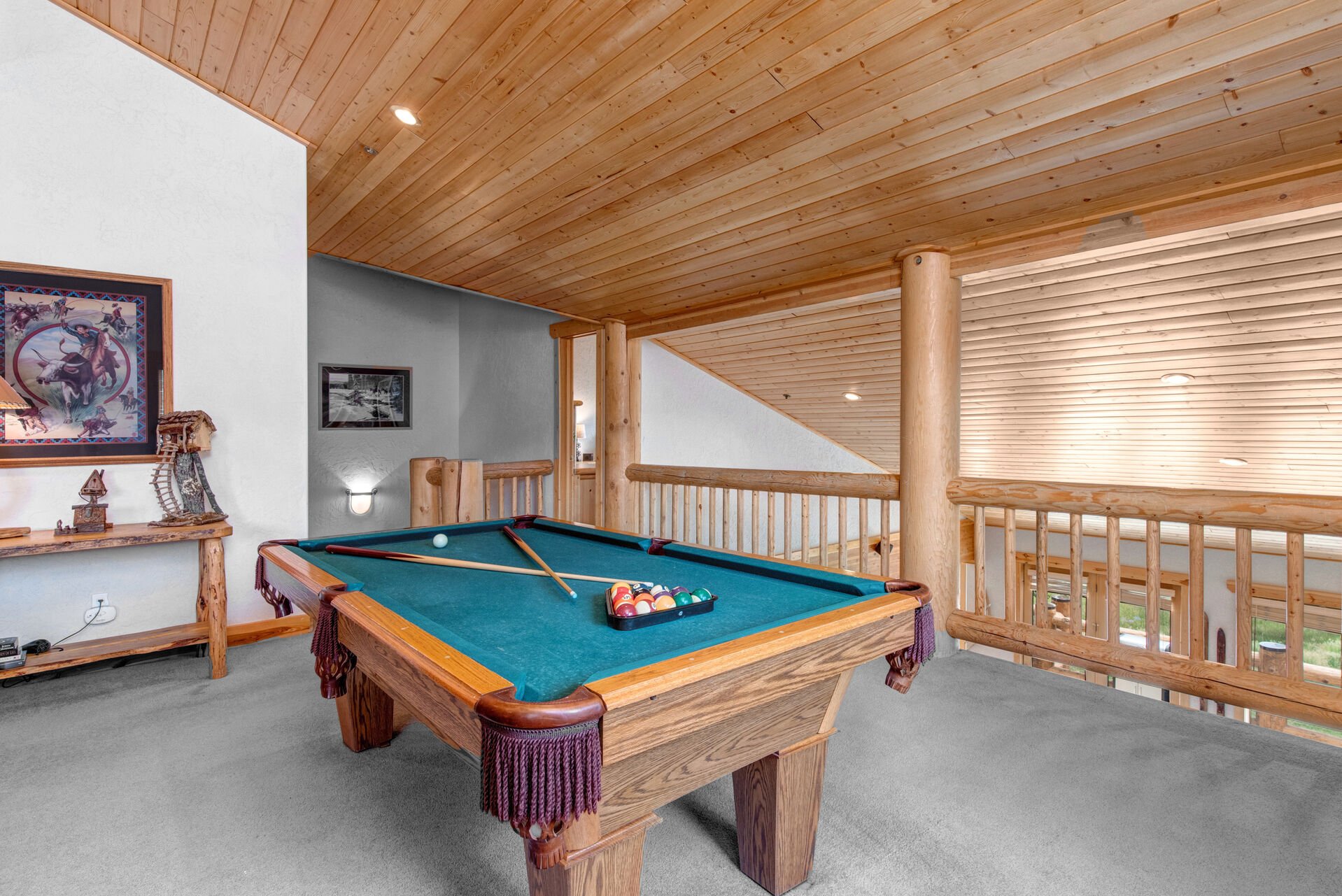 Upper Level Living and Game Room with billiards table, sofa sleeper, smart tv, gas fireplace, and full bath access