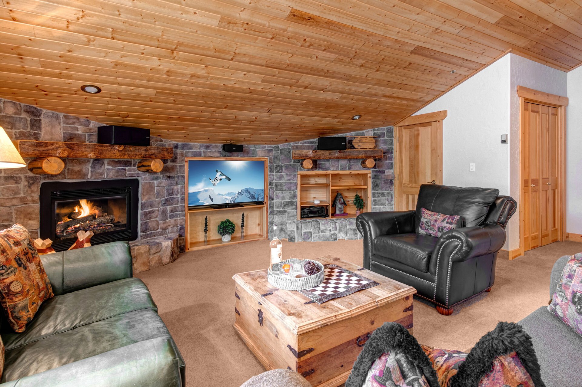 Upper Level Living and Game Room with billiards table, sofa sleeper, smart tv, gas fireplace, and full bath access