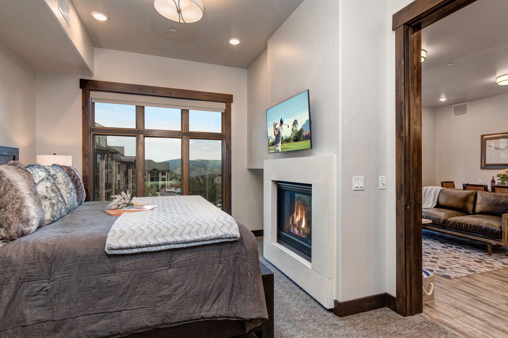 Master Bedroom with king bed, gas fireplace, smart tv, and en suite bathroom