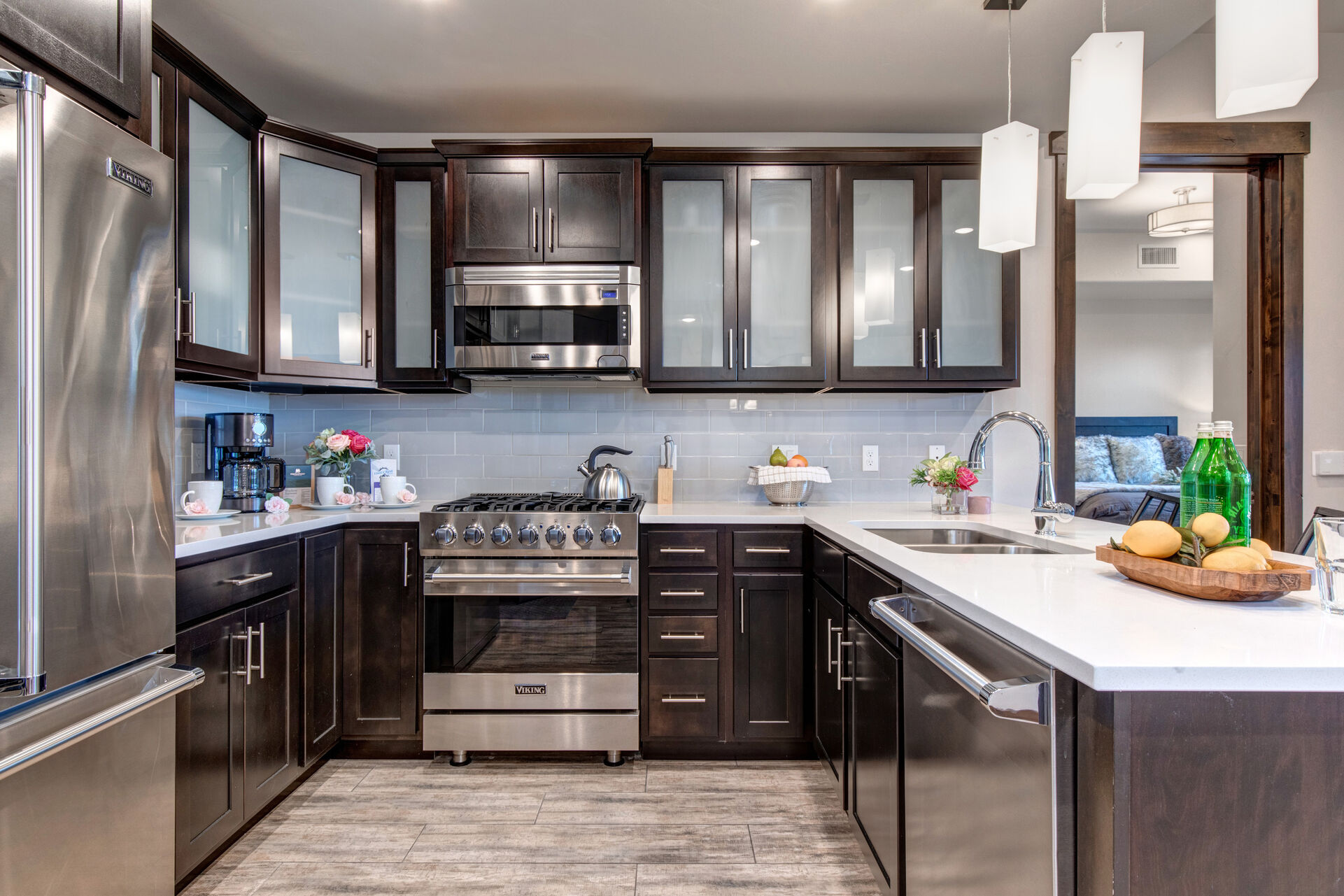 Fully equipped kitchen with gorgeous stone countertops, stainless steel Viking appliances, and bar seating for two