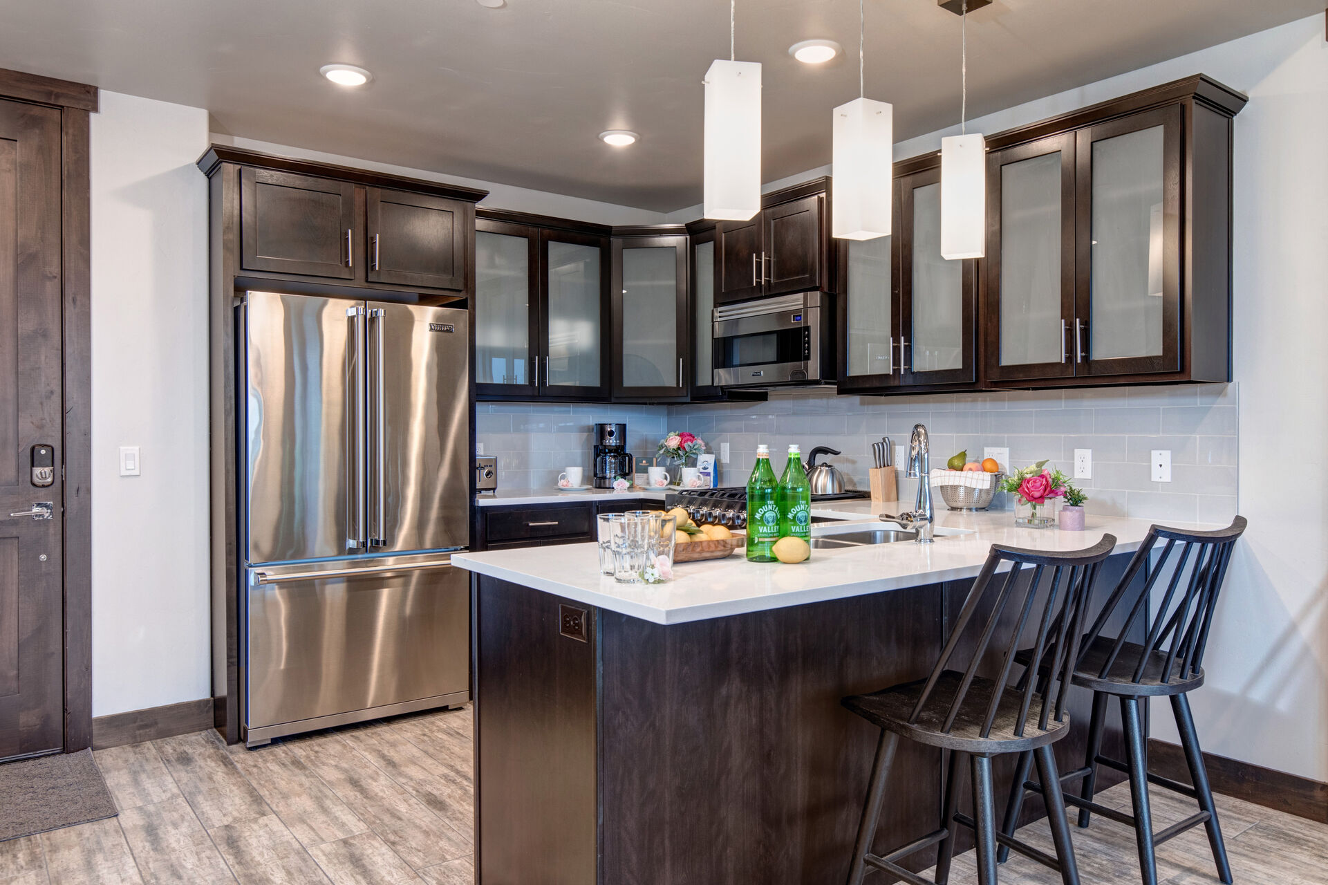 Fully equipped kitchen with gorgeous stone countertops, stainless steel Viking appliances, and bar seating for two