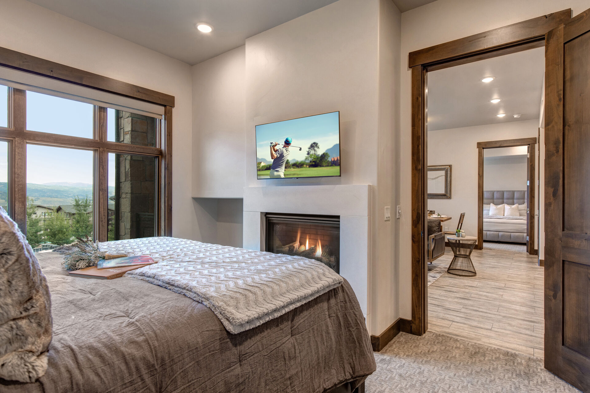 Master Bedroom with king bed, gas fireplace, smart tv, and en suite bathroom