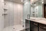Master Bathroom with dual sinks and over-sized tile and glass shower