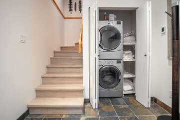 Entryway with in-suite laundry and stairs up to main level