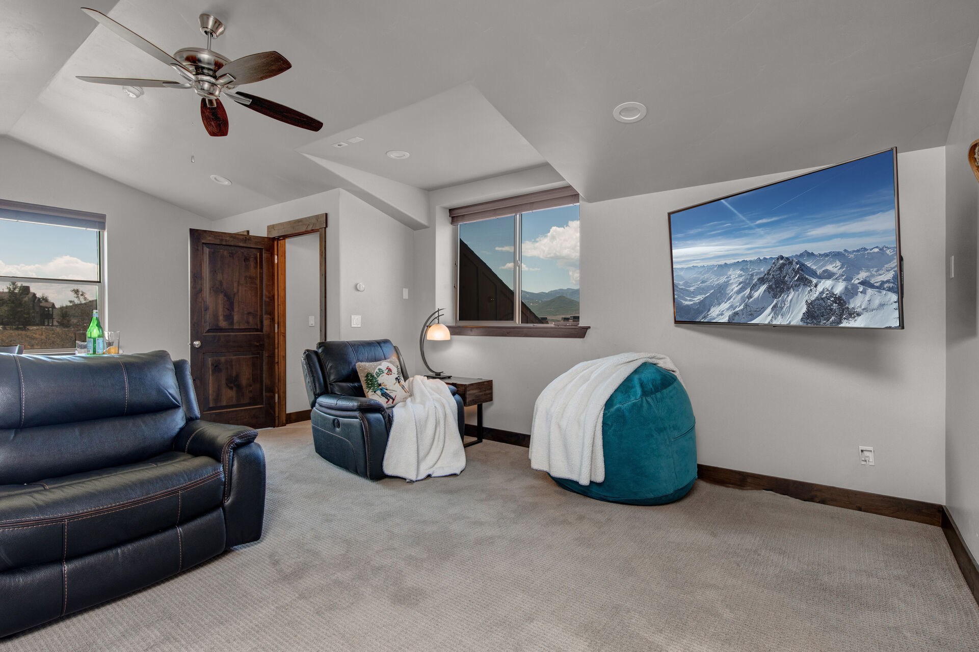 Bonus Room with a Recliner Chair and Large Smart TV