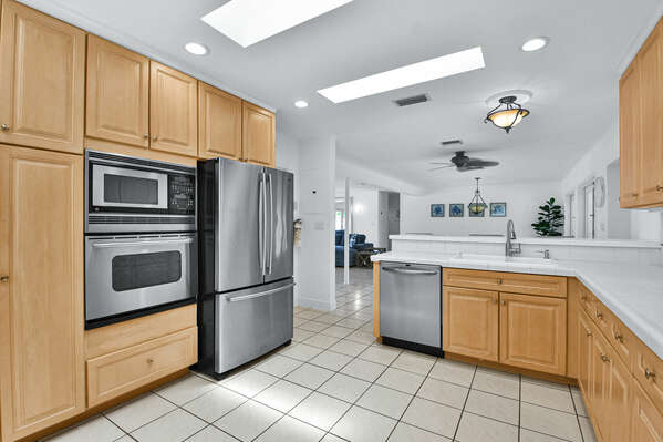 Large, open plan modern kitchen is immaculately clean, equipped fully and ready to use!