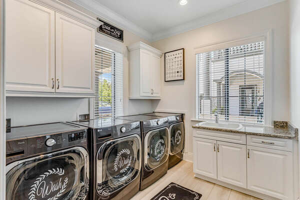 The first floor laundry room includes 2 washers and 2 dryers