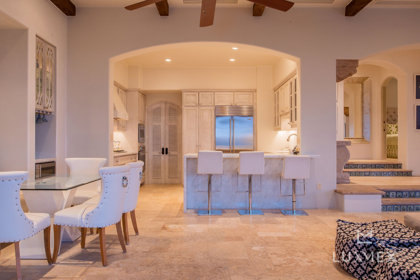 A view into this Los Cabos Luxury Vacation Villa, looking at the kitchen and dining table.