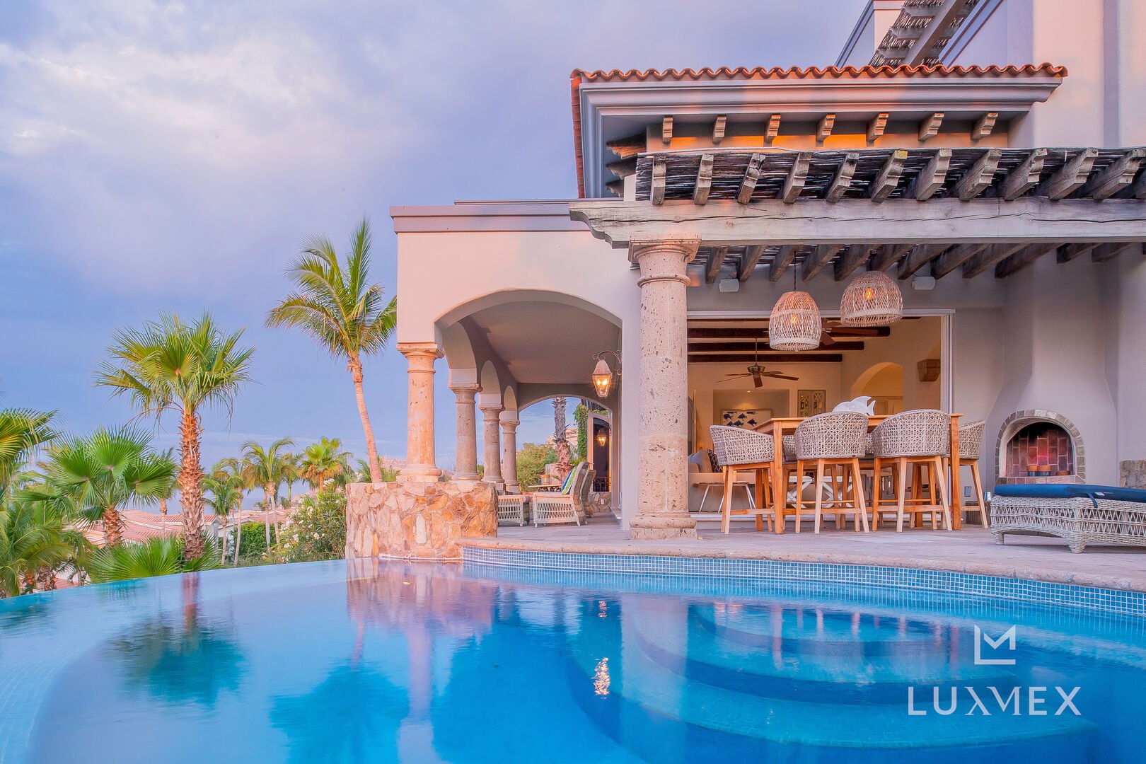 the patio of this Los Cabos Luxury Vacation Villa as seen from inside the pool.