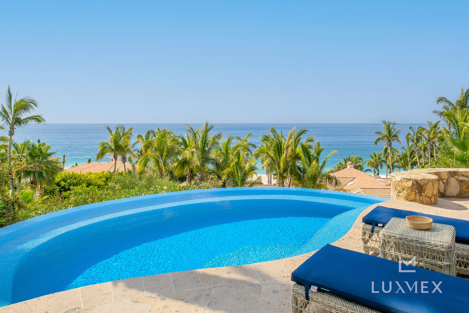 A closer view of this Los Cabos Luxury Vacation Villa's pool and pool chairs.